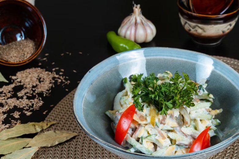 Delicious vegetable salad garnished with fresh herbs and served in a ceramic bowl.